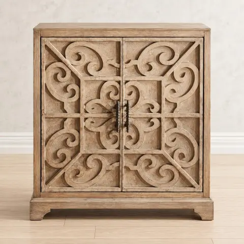 Carved two-door wooden cabinet with symmetrical scrollwork fronts, metal handles and light natural finish styled in a warm living room interior.